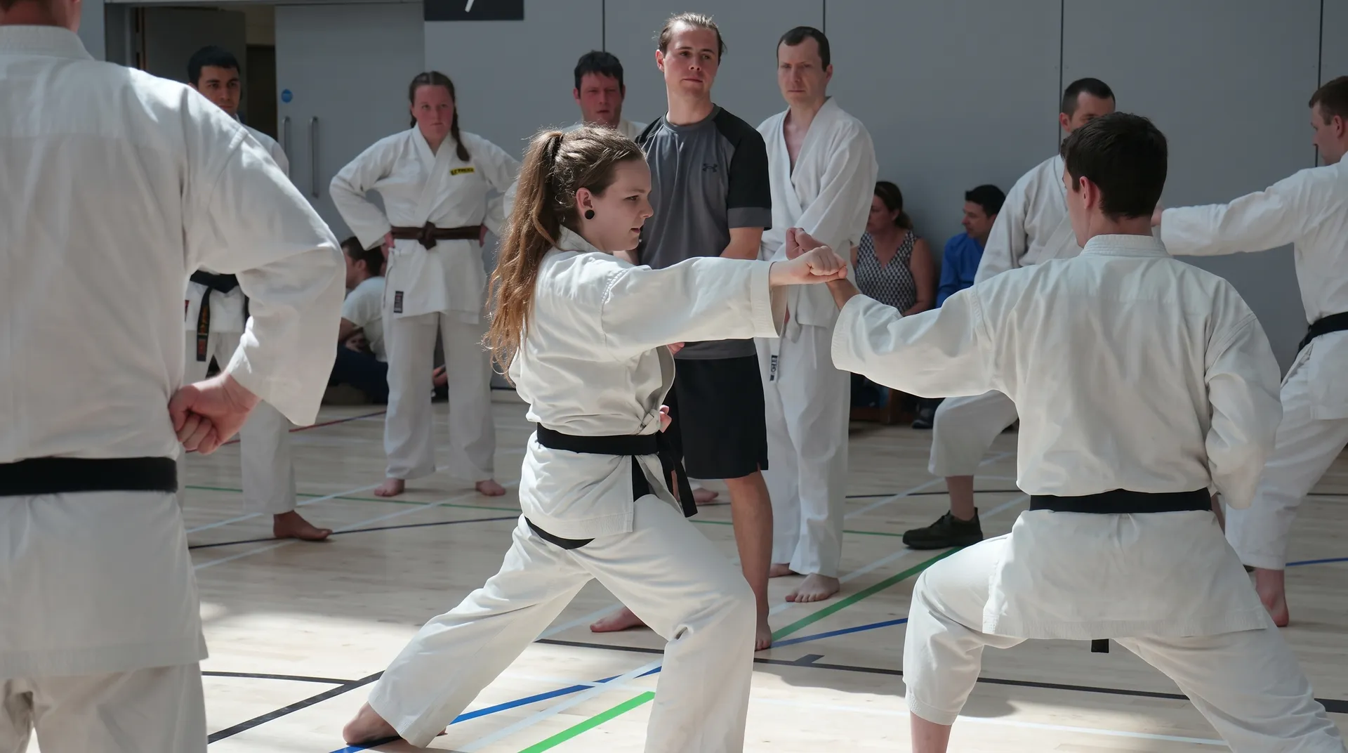 A junior member throwing a punch in a crowded class