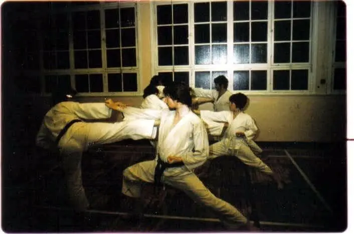 Members training in a dojo with wooden floors, from the archive