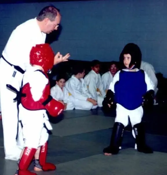 Two juniors sparring in red and blue protective gear