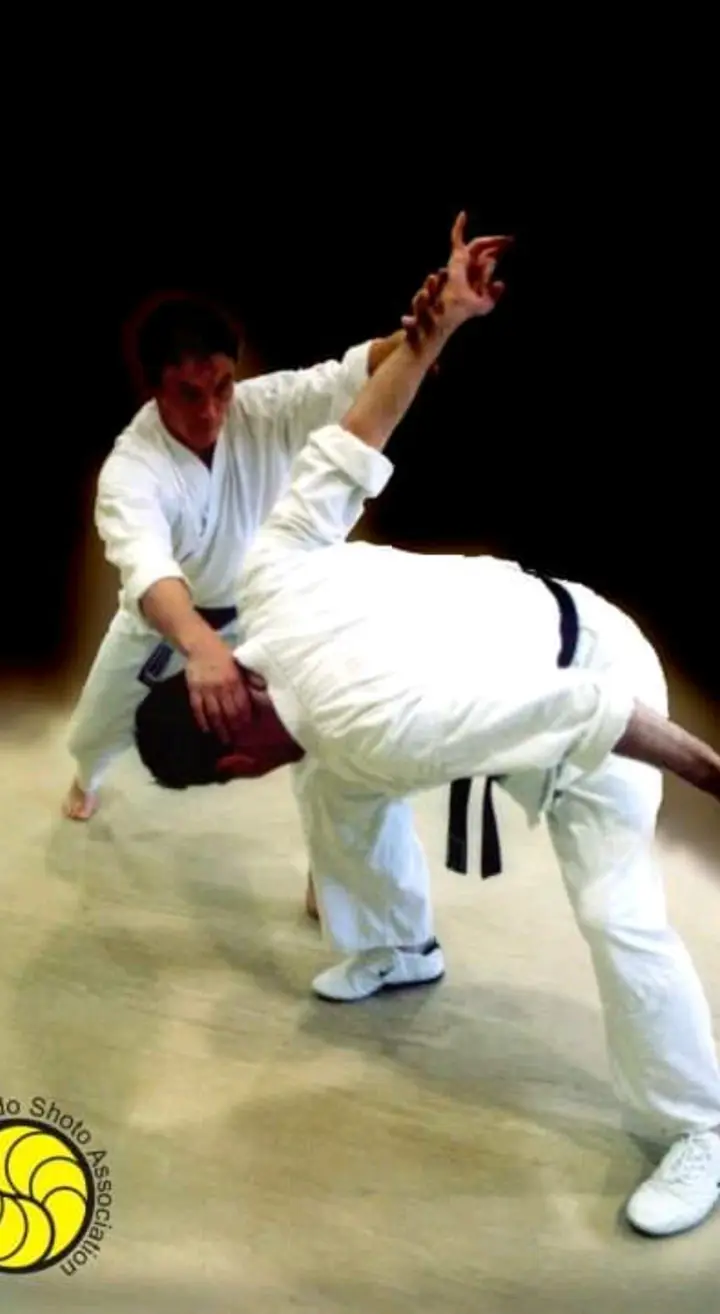 A throw frozen mid-air against a dark background