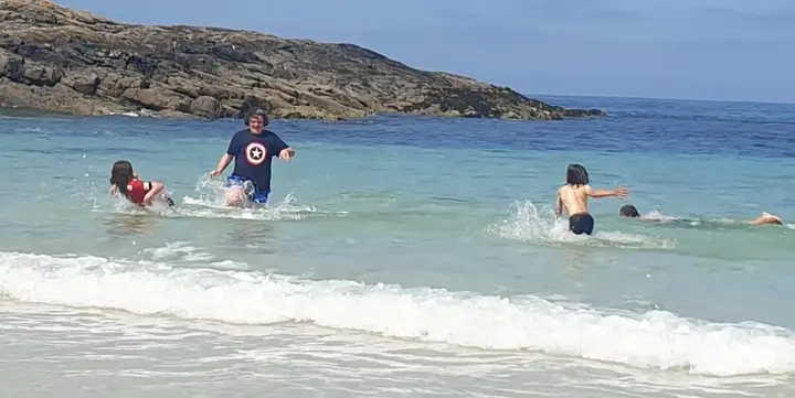 Members splashing into the sea after training