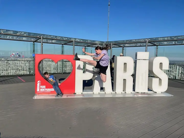 Members posing in front of the Paris sign