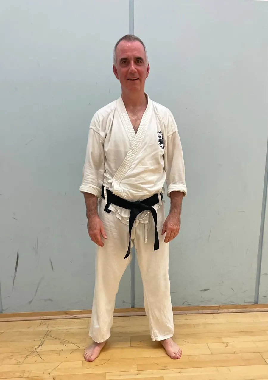 Brendan Owens in a white gi in a sports hall